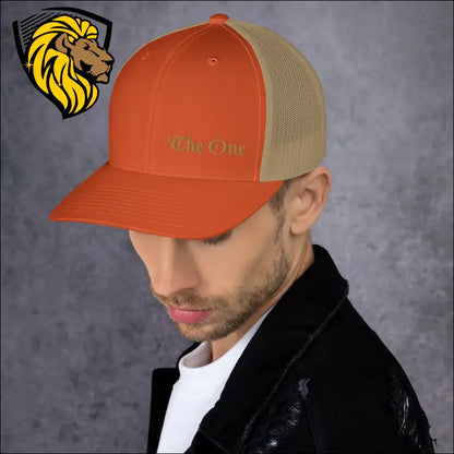 Orange and tan trucker cap with Que Chic embroidery for a stylish look