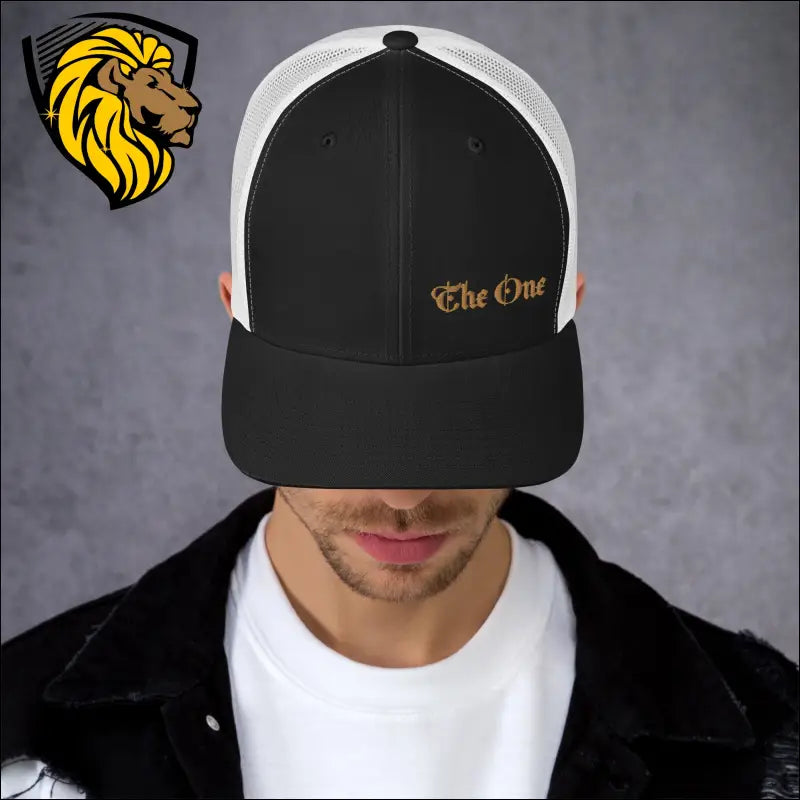 Black and white trucker cap with gold The One embroidery for a bold look