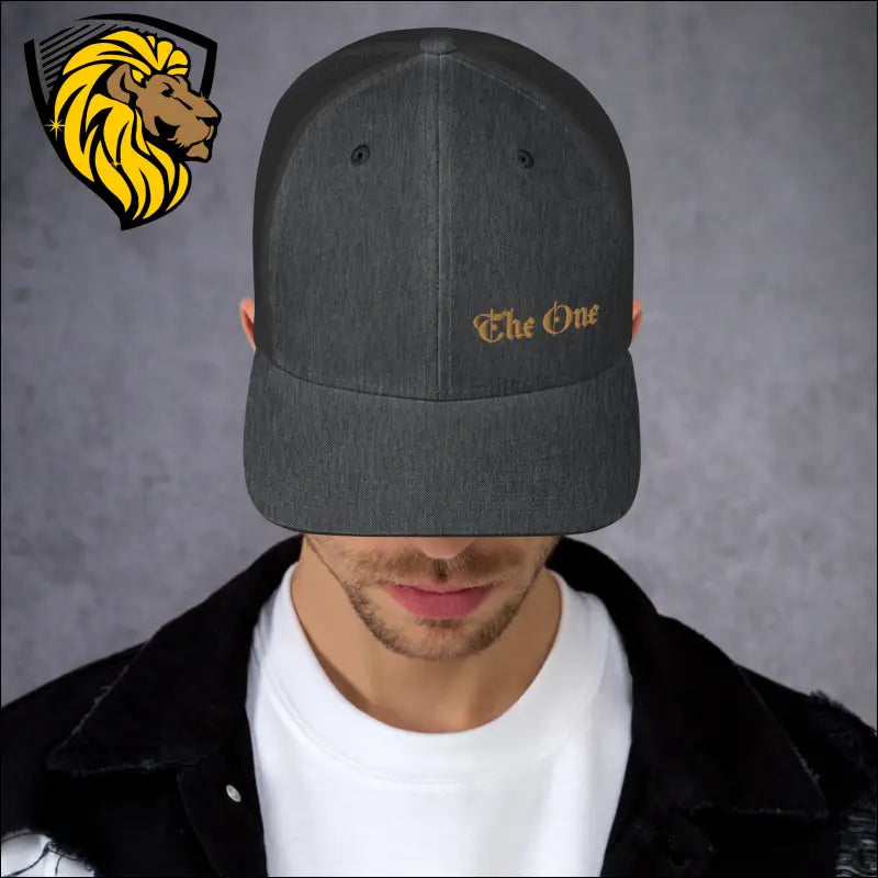 Dark gray trucker cap with The One embroidered in gold for a bold look