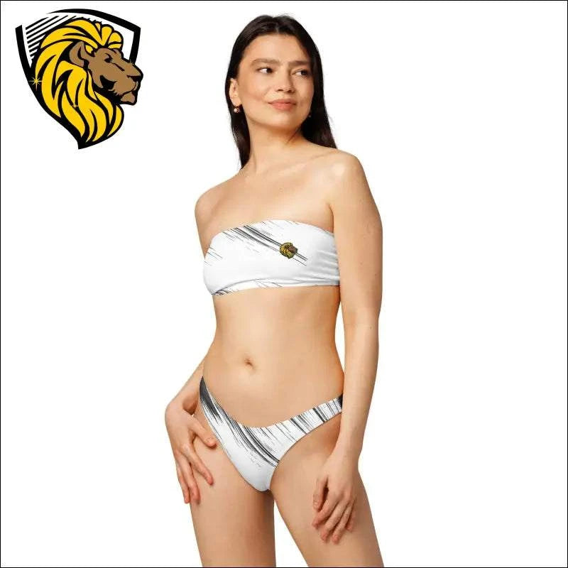 Woman wearing black and white bandeau bikini with lion logo on top