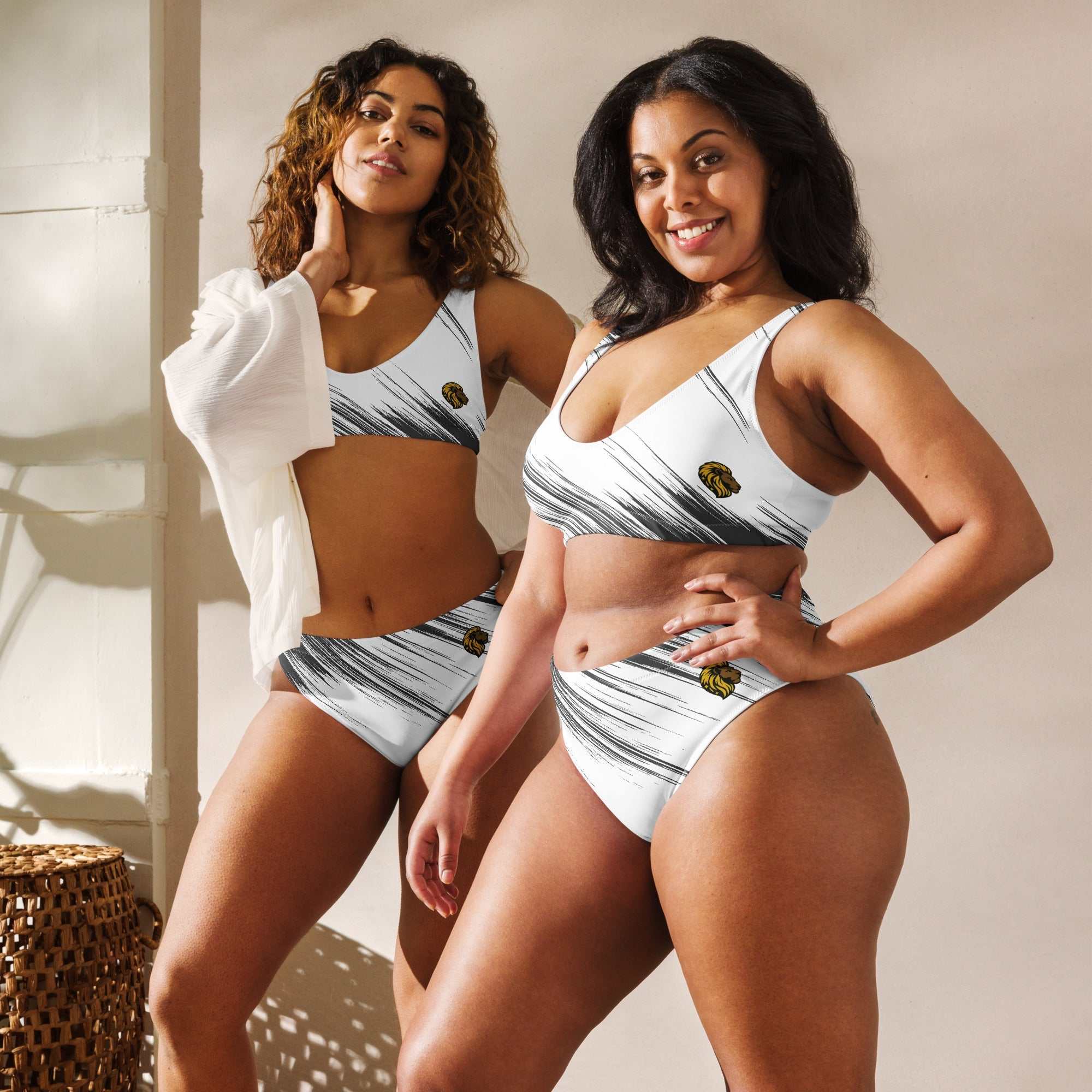 Black and white high-waisted bikini made from sustainable recycled polyester with flattering fit and removable padding.