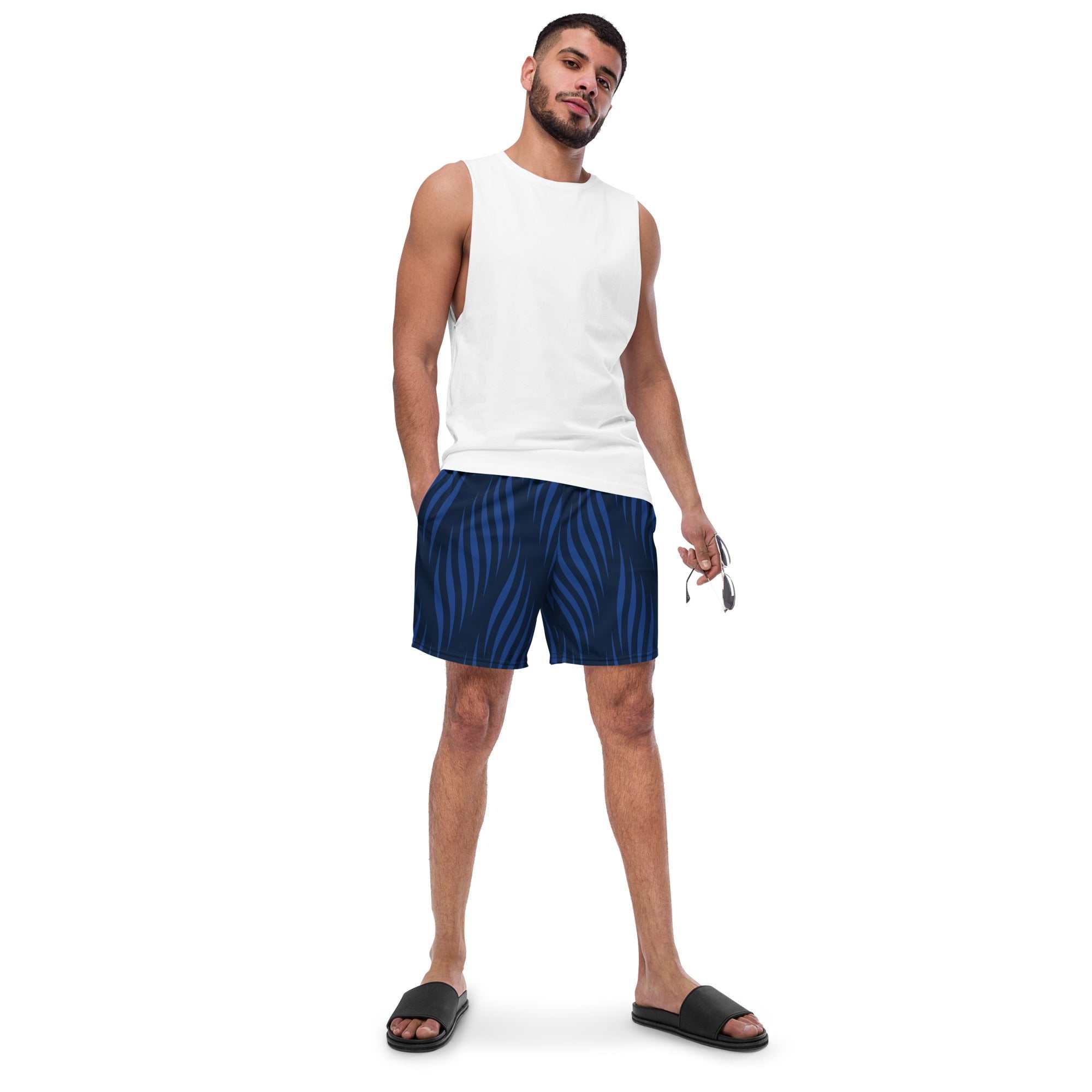 Man wearing Blue Leaf Swim Trunks with eco-friendly fabric and UPF 50+ sun protection standing in casual pose.