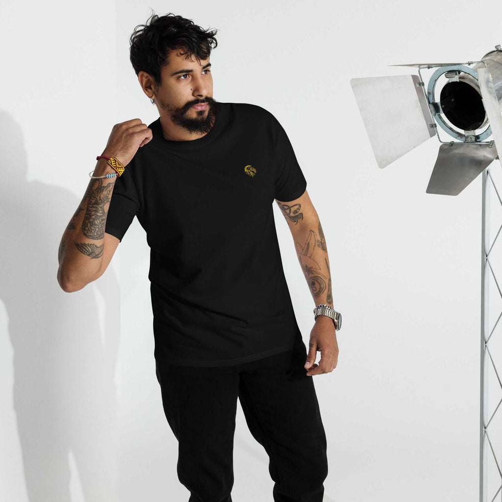 Man wearing black Heavyweight T Shirt with tattoos in studio setting
