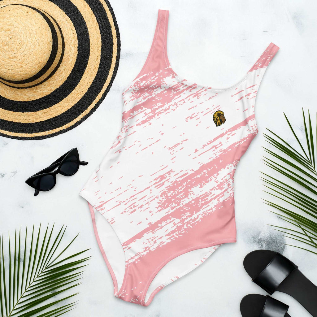 pink slash one-piece swimsuit with chlorine-resistant fabric and Puerto Rican design flat lay with hat sunglasses and sandals