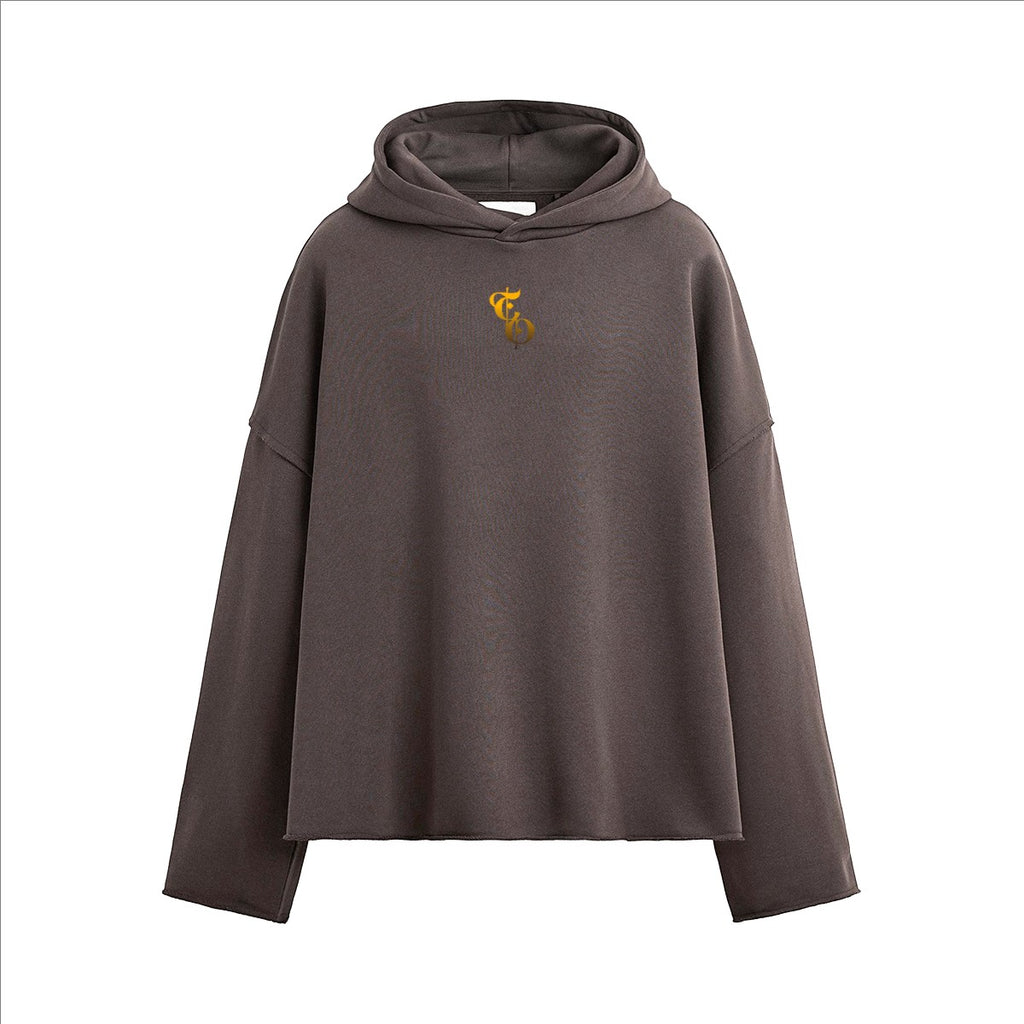 The One PR heavyweight boxy hoodie in dark grey with a gold embroidered logo on the chest. Features a relaxed fit and raw hem.